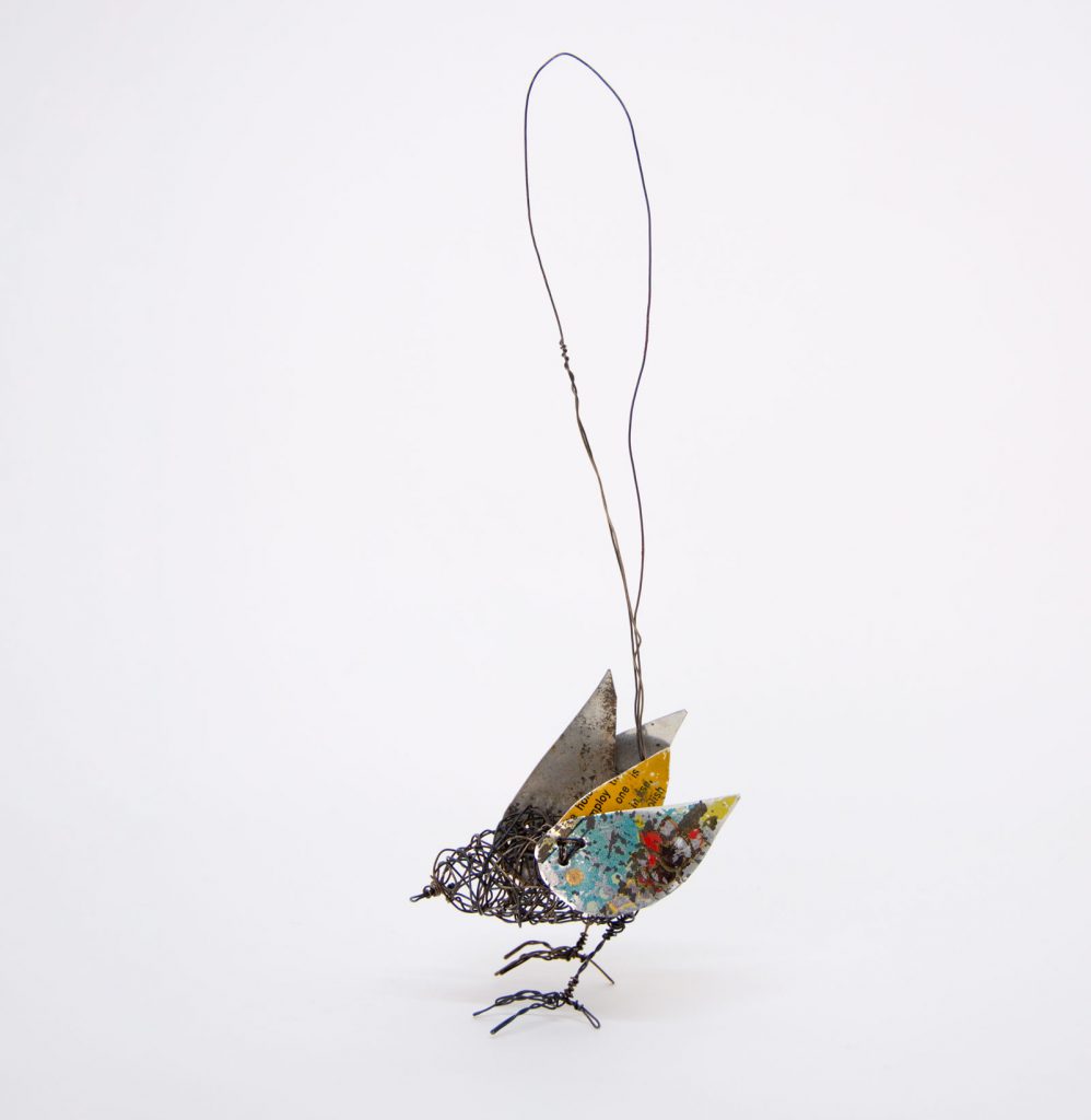 Wire and tin bird sculpture by Ingrid K Brooker. Yellow and blue wings.