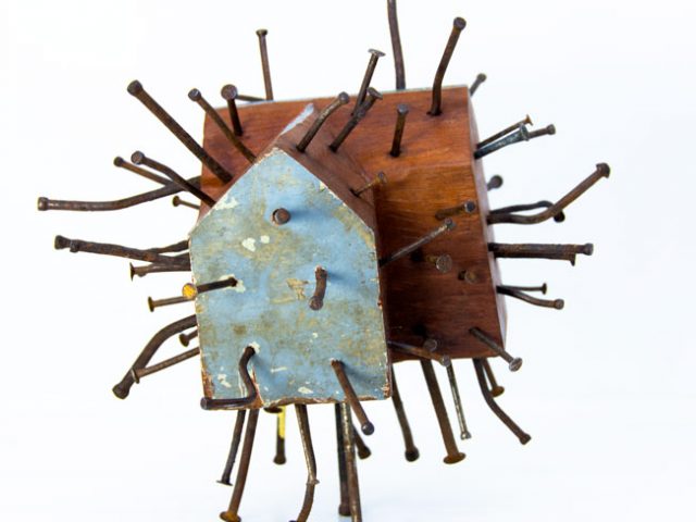 Wooden house sculpture pierced with nails by Ingrid K Brooker